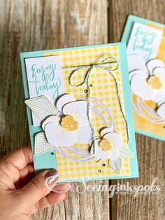 two handmade cards, one with flowers and the other with gingham checks