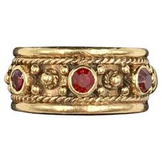 Ornate Renaissance style 14K yellow gold garnet set band ring Late 19th Century Marks: Marker's mark A within a shield, 14K Technique: Twisted gold wire work, granulation, cullet set gemstones Size: 5.75 US Very Good Condition Very fine quality, intricate design and excellent workmanship, Hand crafted by an expert jeweler, this beautiful band is fit for a Renaissance princess or prince. A well rendered maker's mark on the interior of the letter A within a shield shaped crest. The garnets, rich vibrant red in color, faceted, cullet set. An ancient gemstone, garnet has been revered by the Egyptians, Greeks, Romans, Anglo-Saxons, Medieval Crusaders, Hunza warriors, Kings and Queens. It has historically been associated with the heart, inner fire, love, friendship and vitality. Amulets using th 16th Century Jewelry, Medieval Ring, Ancient Jewels, Antique Wedding Bands, Medieval Rings, Medieval Jewelry, Garnet Jewelry, Fame Dr, Gold Band Ring