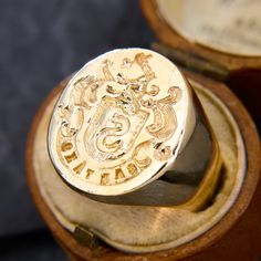 This fantastic 14k yellow gold signet or seal ring features an oval face with gold carvings and a banner that reads "SANTAKO." The ring has great heft and a comfortable fit, it is currently a size 7.25. Classic Signet Ring For Commemoration, Antique Oval Signet Ring With Polished Finish, Classic Engraved Signet Ring For Commemoration, Luxury Engraved Ring With Polished Finish For Commemoration, Luxury Engraved Ring For Commemoration With Polished Finish, Luxury Engraved Signet Ring For Commemoration, Classic Signet Ring With Engraving For Commemoration, Classic Engraved Signet Ring For Ceremonial Occasions, Classic Engraved Signet Ring For Ceremonial Use