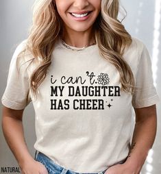 a woman wearing a t - shirt that says i can't my daughter has cheer