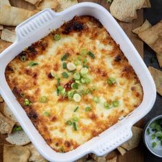 a casserole dish with green onions and cheese