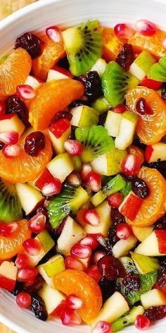 a white bowl filled with sliced fruit on top of a wooden table