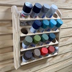 a wooden shelf with many different colors of paint on it