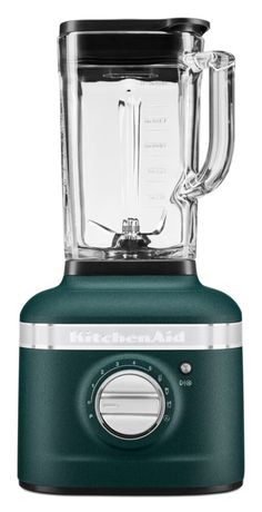 a green blender sitting on top of a white table