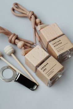 three small wooden boxes sitting on top of a table next to a pair of scissors