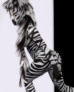 a woman dressed in zebra print poses for the camera