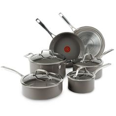 an assortment of pots and pans on a white background