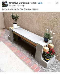 a bench made out of cinder blocks with potted plants