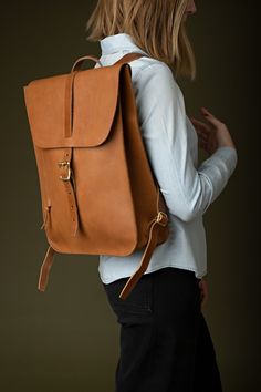 The perfect leather backpack for daily use. A dedicated laptop sleeve can fit laptops up to 16". Internal and external pockets to keep everything else organized. This sturdy leather backpack is a robust companion that carries everything yet fits every frame. Add a monogram to let them know it's yours. Diy Leather Backpack, Leather Bookbag, Backpack Outfit, Luxury Backpack, Work Backpack, Leather Laptop Backpack, Backpack Pattern, Leather Rucksack, Women Leather Backpack