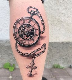 a tattoo on the leg of a person with a pocket watch and chain around it