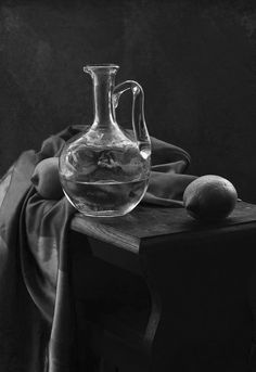 black and white photograph of a glass pitcher on a table