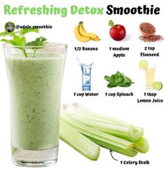 a glass filled with green smoothie next to celery