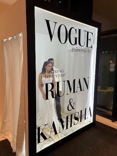 an advertisement for a wedding dress shop is displayed in front of a curtained window