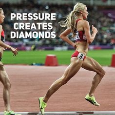 a woman running on a track in a stadium