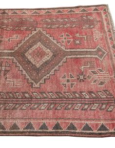 an old rug is shown on a white background with red and brown colors, including the design