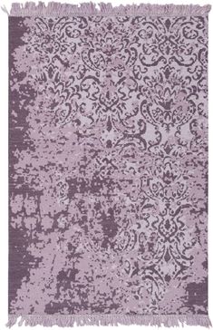 a purple rug with an intricate design on the top and bottom, along with fringes