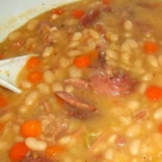 a white bowl filled with beans and carrots