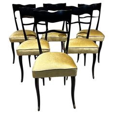 six black chairs with yellow upholstered seats