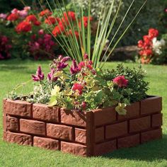 a brick planter filled with lots of flowers