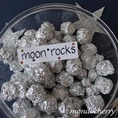 a bowl full of silver colored rocks with a sign that reads moonrocks on it