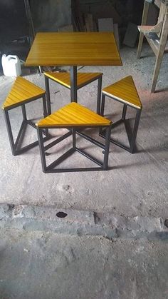 three tables and four chairs sitting on the ground