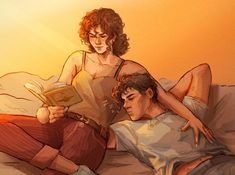 two people are laying on a bed and one is reading a book while the other looks at it