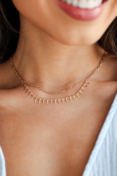 You'll always impress your admirers in the Kaia Gold Layered Chain Necklace! This trendy necklace features two layers of gold chains. Style the Kaia Necklace with any outfit to instantly upgrade your look! Gold Plated Layered Lobster Clasp with Extender Layer 1 | Length 6.5" Layer 2 | Length 6" Extender | Length 3" Trendy Double Strand Figaro Chain Necklaces, Trendy Double Strand Figaro Chain Necklace, Double Strand Layered Necklace With Figaro Chain, Gold Layered Charm Necklace Choker, Dainty Metal Layered Necklace With Double Chain, Dainty Metal Double Chain Layered Necklace, Gold-tone Layered Choker Necklace With Clavicle Chain, Gold-tone Clavicle Chain Layered Choker Necklace, Gold-tone Layered Clavicle Chain Choker