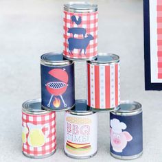 several tin cans with different designs on them