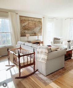 a living room filled with furniture and a baby crib