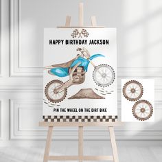 a birthday card with a dirt bike on it and an easel next to it that says, happy birthday jackson pin the wheel on the dirt bike