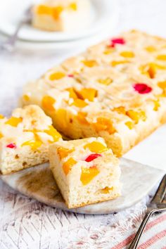 two pieces of cake sitting on top of a plate next to a knife and fork