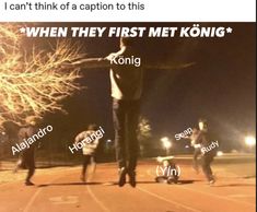 a group of people standing on top of a road at night with words written in front of them