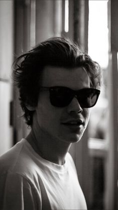 black and white photograph of a man wearing sunglasses