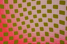 a pink and green quilt with squares on it