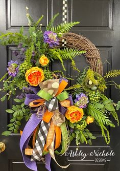 a wreath on the front door decorated with flowers