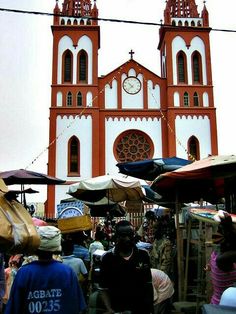 people are walking around in front of a church