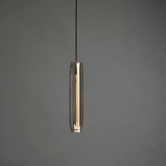 a light that is hanging from the ceiling in a room with gray walls and flooring