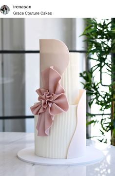 a white and pink cake with large flowers on it