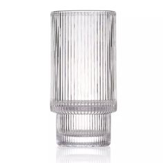 a tall glass vase sitting on top of a table