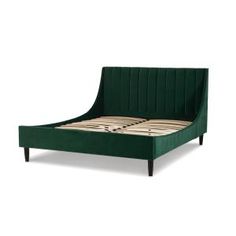 the bed frame is made up in green velvet