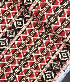 a red and black patterned fabric with brown accents