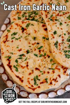 three flat breads on a plate with the title cast iron garlic naan