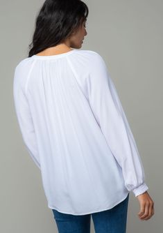 A classic bohemian button-front blouse in a soft and silky crepe. Silky crepe Relaxed fit Long voluminous sleeve Smocked elastic wrist cuff Split v-neckline Button front Bohemian blouse For the office and beyond, this classic button-front blouse is the go-to style of the season. Designed in a soft and silky crepe. Featuring voluminous long sleeves, smocked elastic wrist cuffs, and an ultra-relaxed fit. Model is 5'9, wearing a size S.Style: I-13877W-RPL Fall V-neck Peasant Top With Smocked Cuffs, Casual Flowy V-neck Peasant Top, Casual V-neck Peasant Top With Smocked Bodice, Spring V-neck Peasant Top With Blouson Sleeves, Bohemian V-neck Top With Smocked Back, Bohemian V-neck Tops With Smocked Back, Elegant V-neck Peasant Top For Fall, Relaxed Fit V-neck Blouse For Brunch, V-neck Smocked Top For Brunch