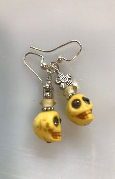 Yellow Dyed Howlite Skeleton Beads, Glass Beads, Silver Tone Beads, Swarovski Crystal Eyes, Silver Platted Earring Loops  Earrings: 1 3/4 inches  Yellow Skeleton Beads: 10 mm Handmade Adjustable Bone Colored Earrings, Adjustable Bone Colored Beaded Jewelry, Adjustable Beaded Bone Jewelry, Adjustable Skull-shaped Earrings With Ear Wire, Adjustable Skull Shaped Earrings With Ear Wire, Halloween Earrings Diy, Yellow Skeleton, Loops Earrings, Cave Creek Az