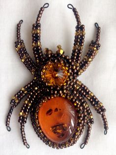 "Buy the Spider jewelry as unique Halloween brooch. Spider pin has a has a size approximately 2*3 inches (5*7,5 cm). This Beaded insect brooch is the best Halloween gift. A Spider jewelry brooch is carefully bead embroidered on leather using Czech crystals, seed beads. The central element can be made of imitation of amber, other gemstone or crystal to your order. * Size gold insect brooch: approx. 2*3 inches (5*7,5 cm) with a sweep of all his paws * Color customization for custom orders is avail Handmade Brooches For Halloween Gift, Brooch Embroidery, Spider Brooch, Spider Crafts, Insect Brooch, Spider Jewelry, Beaded Brooches, Beaded Spiders, Felt Beads