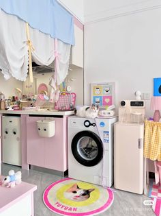 a child's play room with pink furniture and accessories, including a washing machine