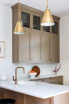 a kitchen with two pendant lights over the sink