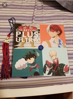 some anime books are laying on a bed with a tassel hanging from it's end