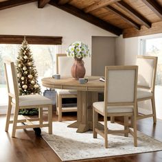 a dining room table with chairs and a vase filled with flowers on top of it