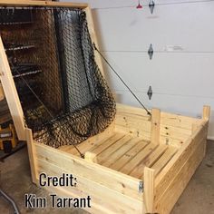 a bed made out of wood and wire in a garage with the words credit kim tarrant on it